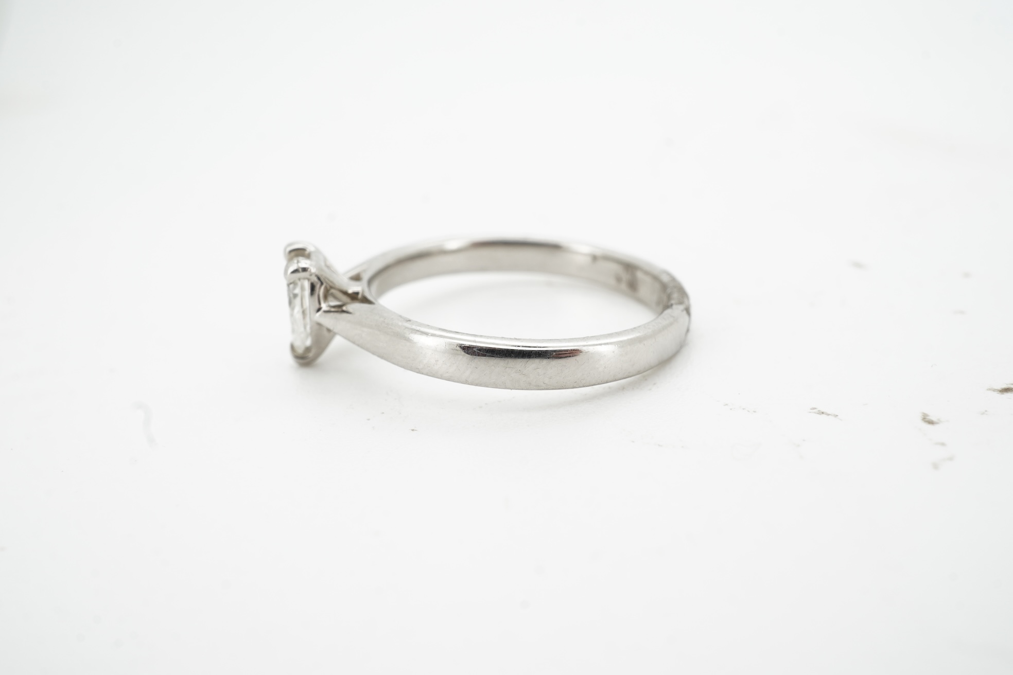 A diamond ring, claw-set with a pear-shaped diamond weighing approximately 0.45 carats, mounted in platinum, size L1/2, British hallmarks, gross weight approximately 4 grams